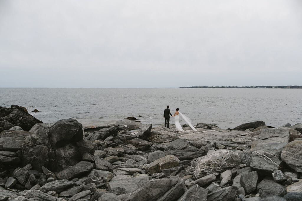 Kat and Jay walking on Sachuest Point after their ceremony
