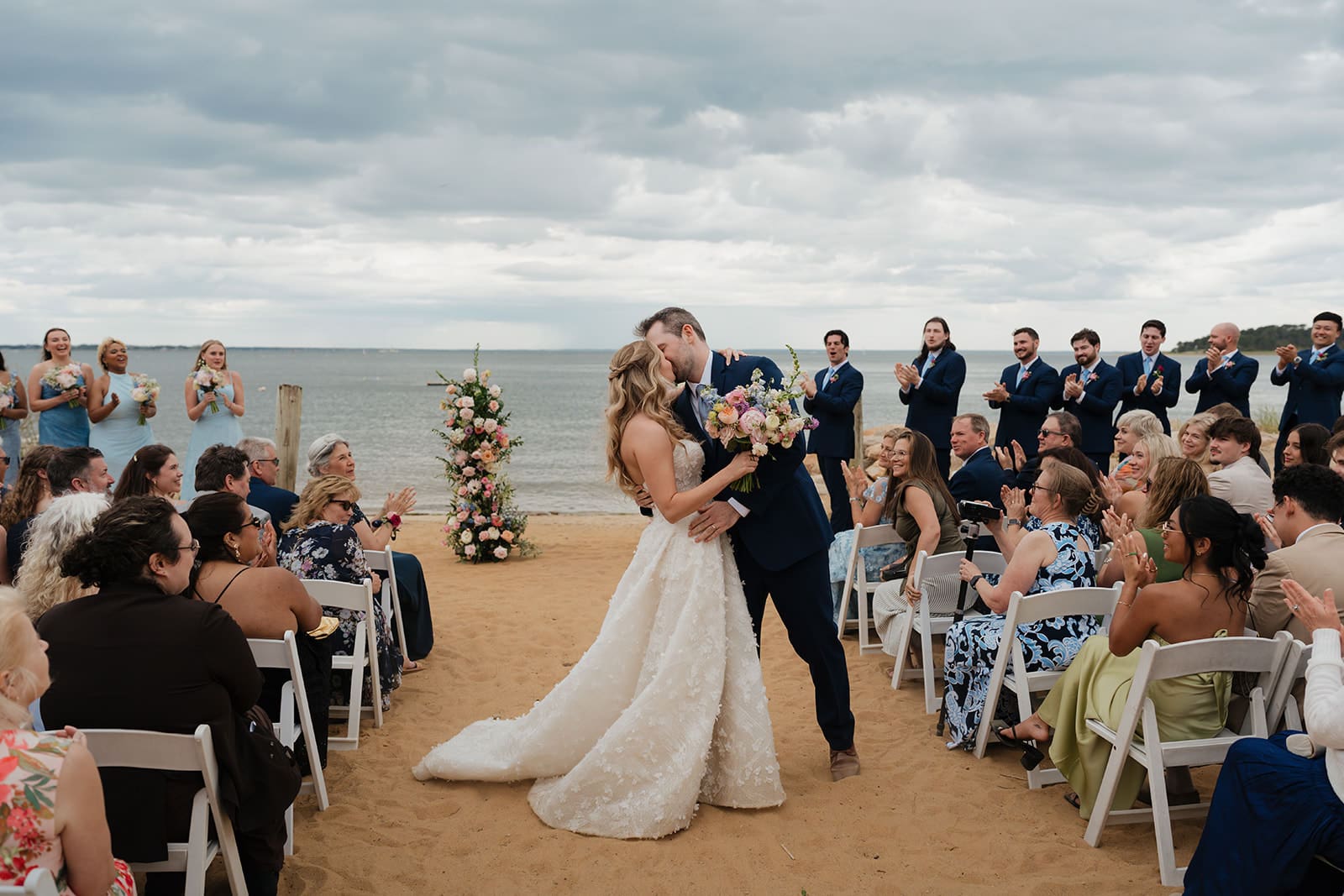 Beach ceremony at a Chequessett Club wedding with the ocean behind the couple